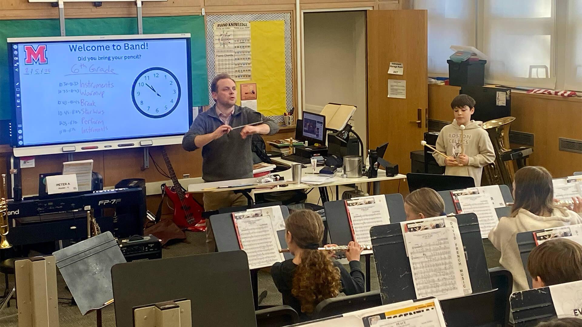 male music teacher leading a band class