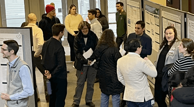a group of people at a poster session