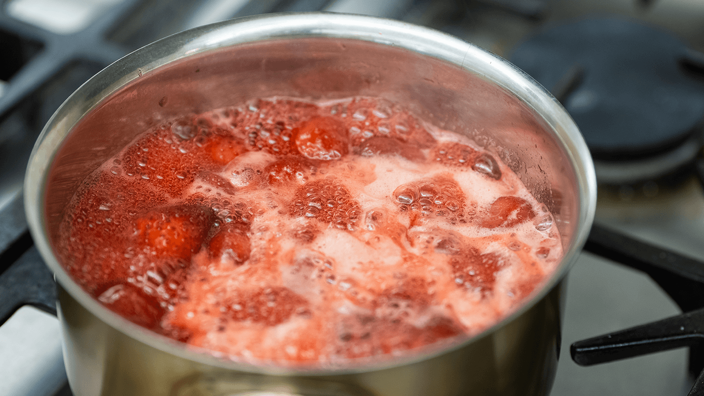Strawberries boiling in a pot