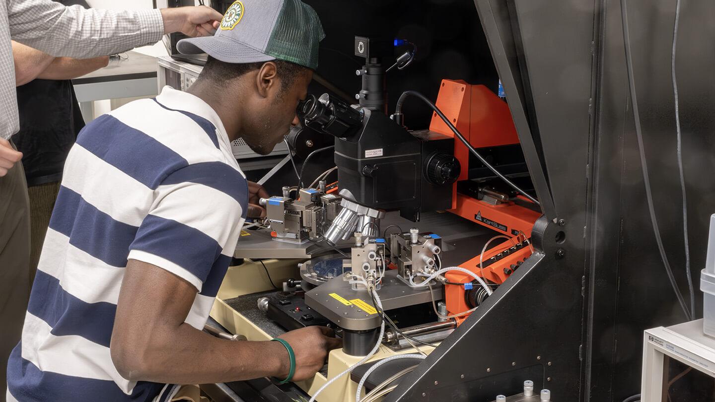 CEMS student uses a semiconductor probe in the device Characterization lab