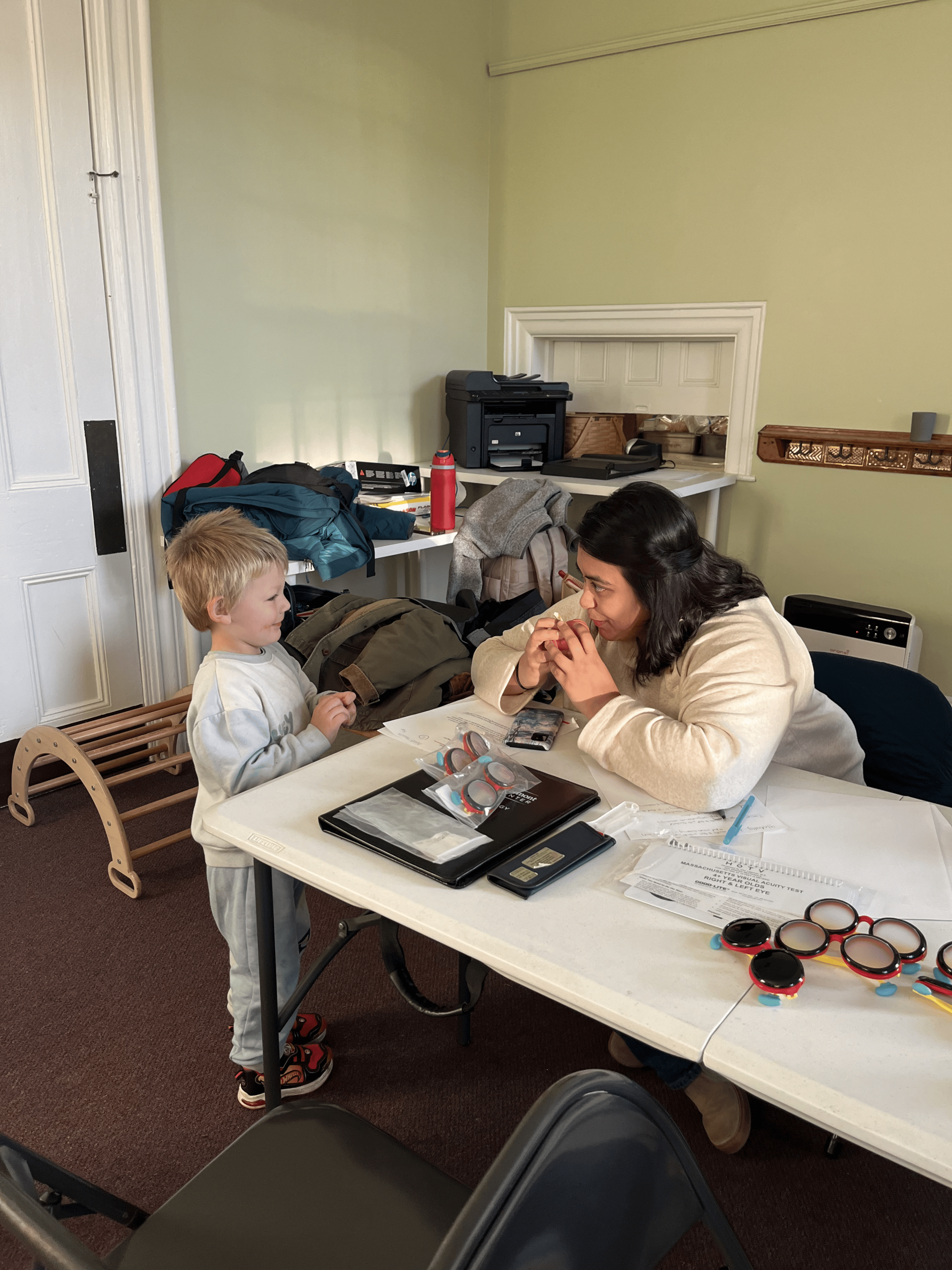 A young boy and adult woman play together