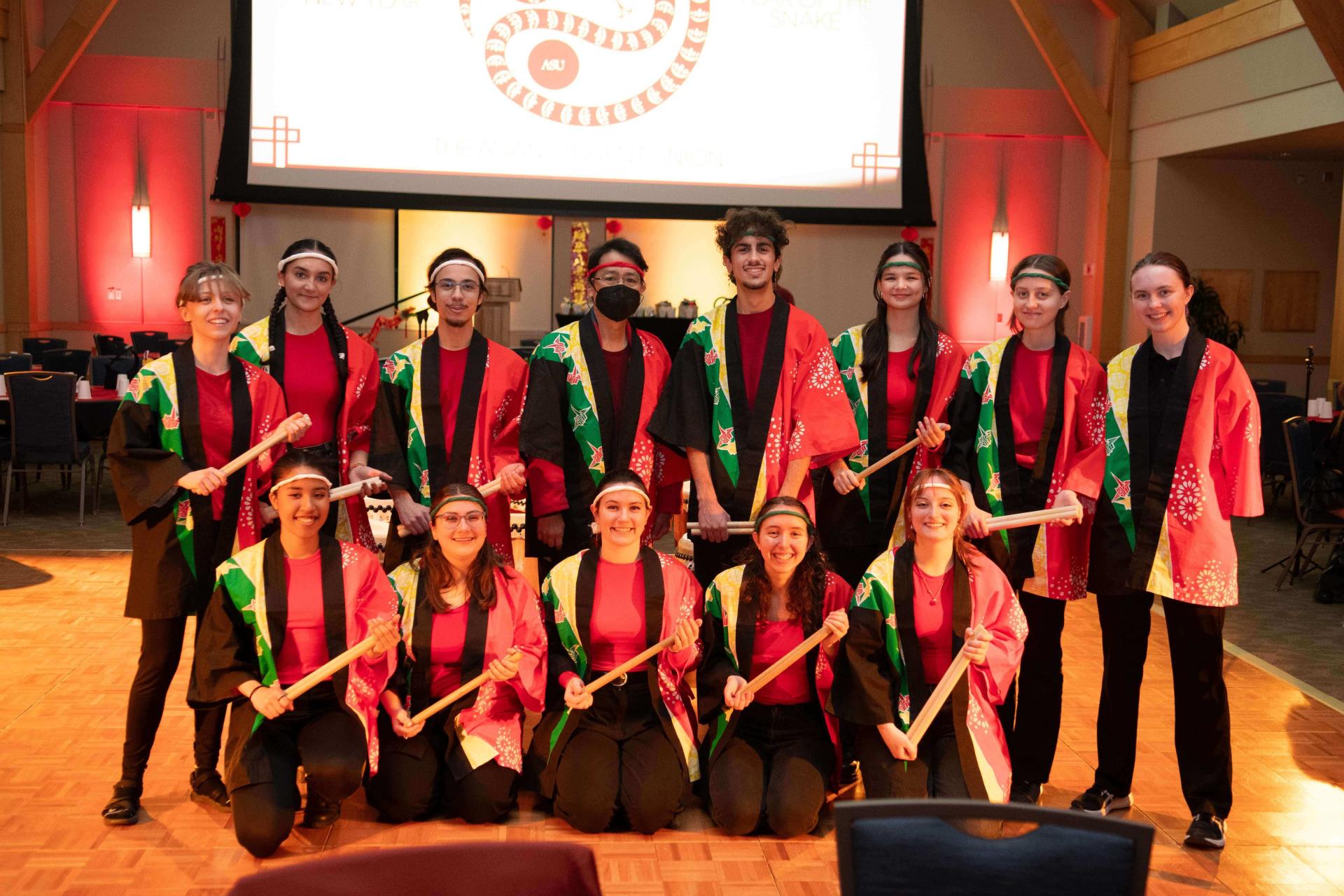 A gathering of young individuals in bright red and green clothing