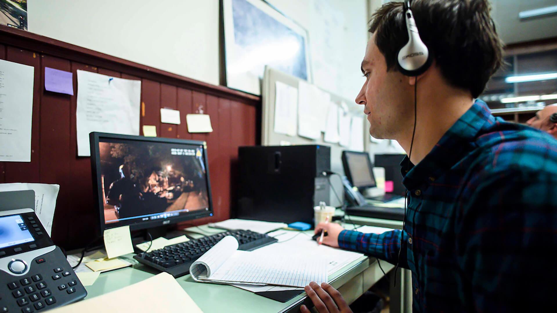 University of Vermont environmental studies major Luke Zarzecki, a junior form Chicago IL, reviews police body camera footage as part of his internship