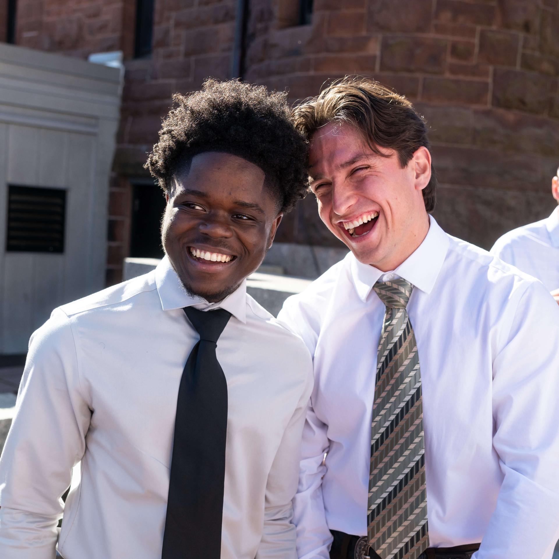 two students smiling at the camera