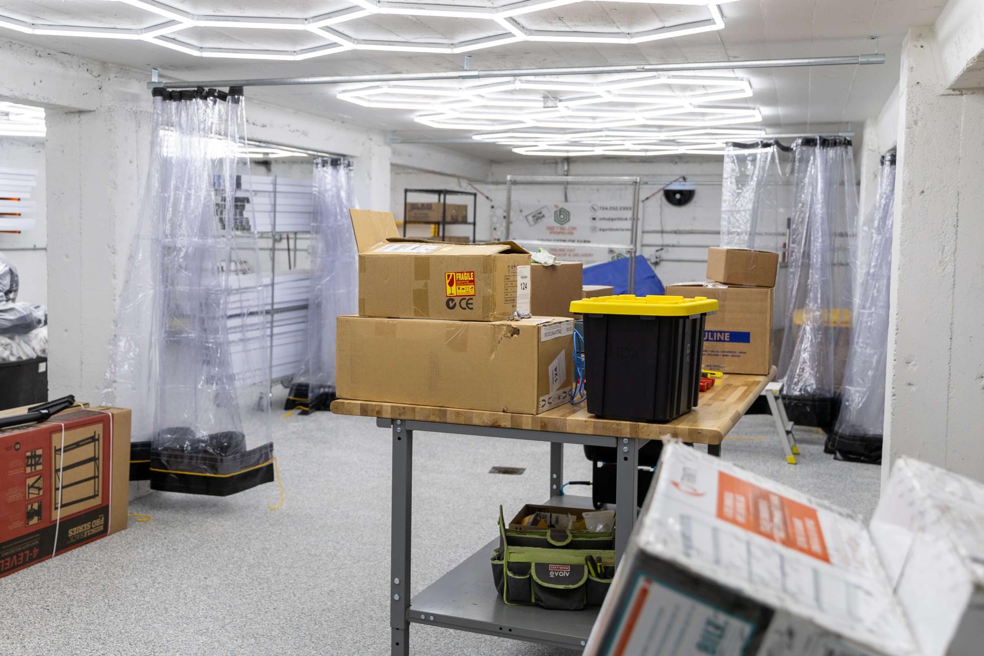 Concrete room with plastic curtains to contain water during power-washing