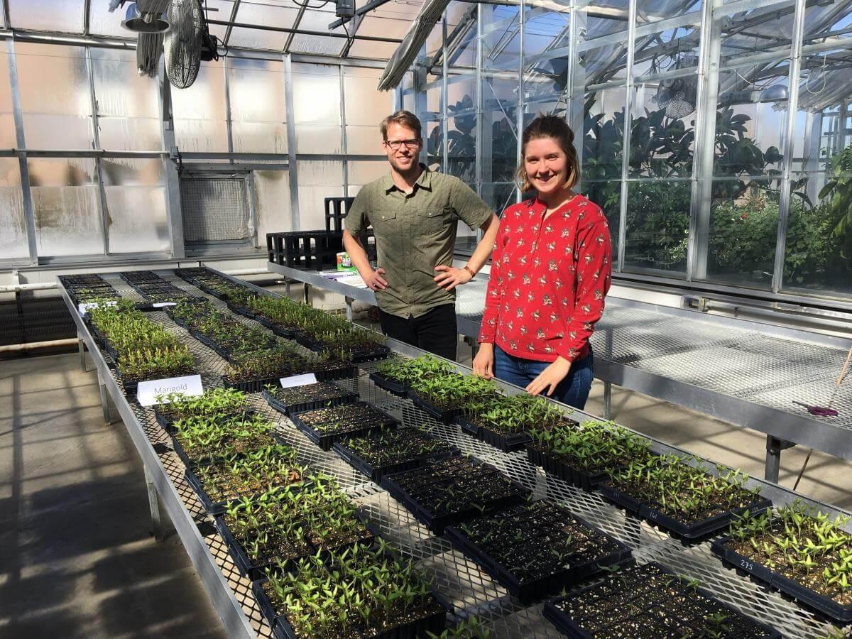 Eric Roy and Kate Porterfield standing in a greenhouse 