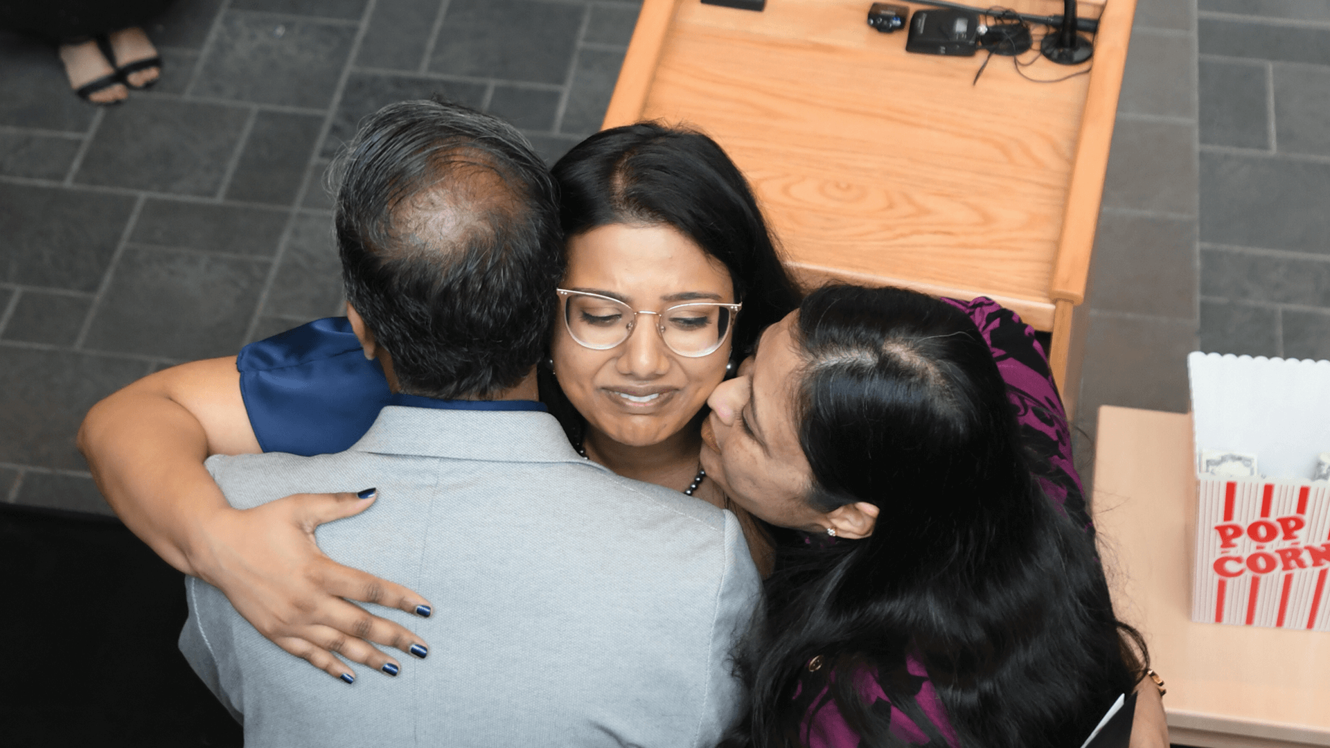 a woman hugs her parents