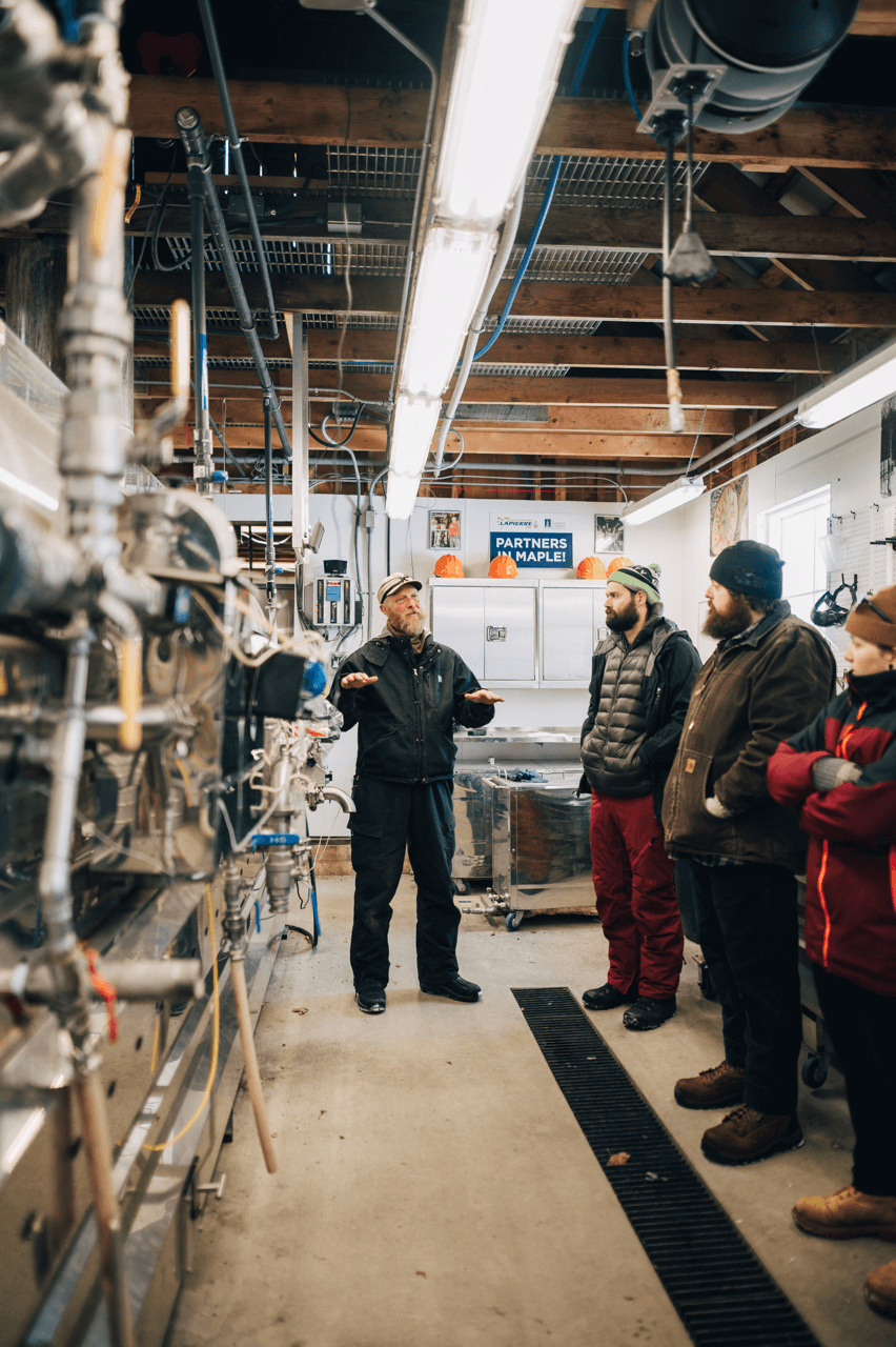 People inside a sugarhouse getting a tour