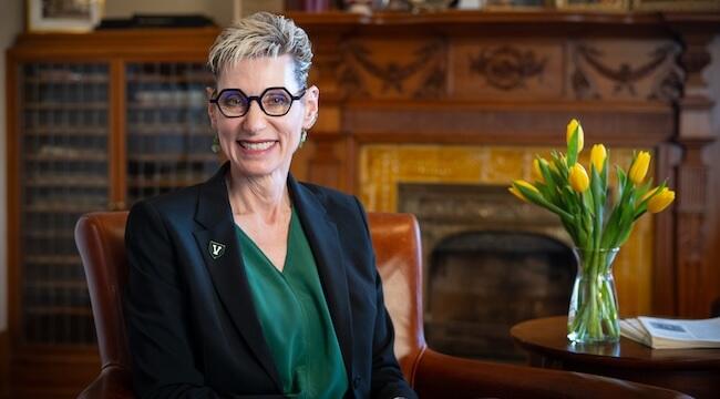 Portrait of Dr. Marlene Tromp sitting on an armchair
