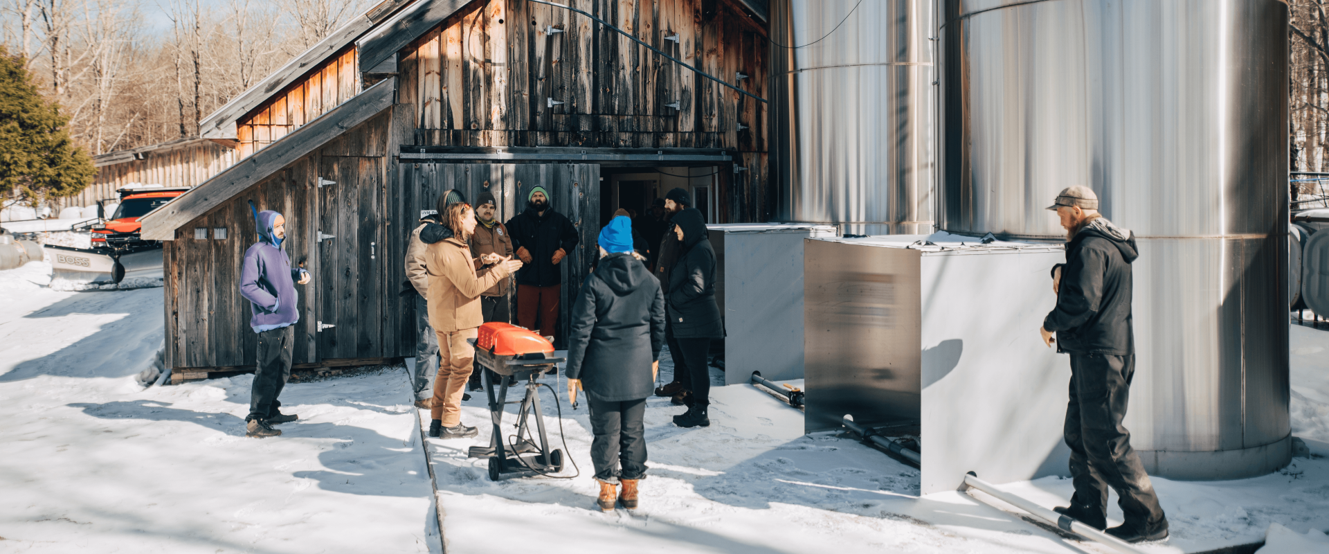 People outside of a sugarhouse