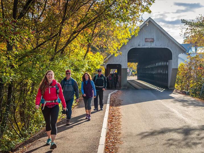 people walking near a covered bridge