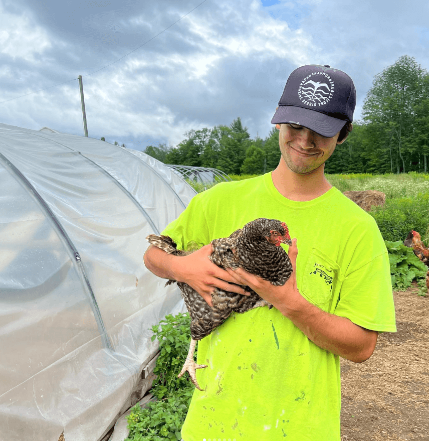 a person holding a chicken 