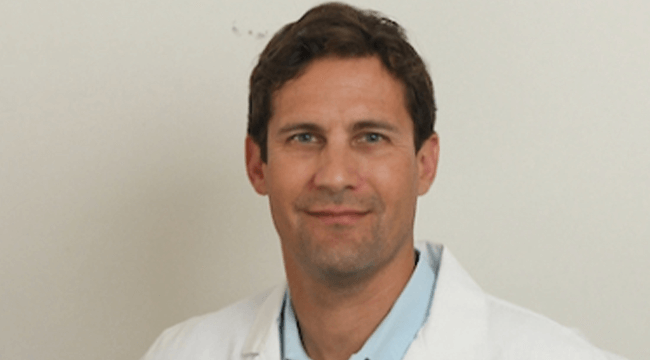 a man in a white coat