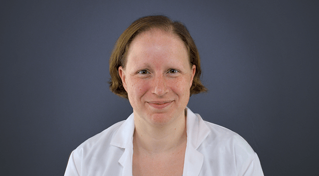 a woman in a white coat