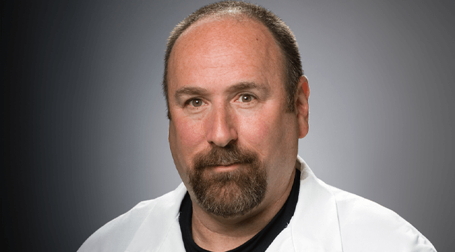 a man in a white coat