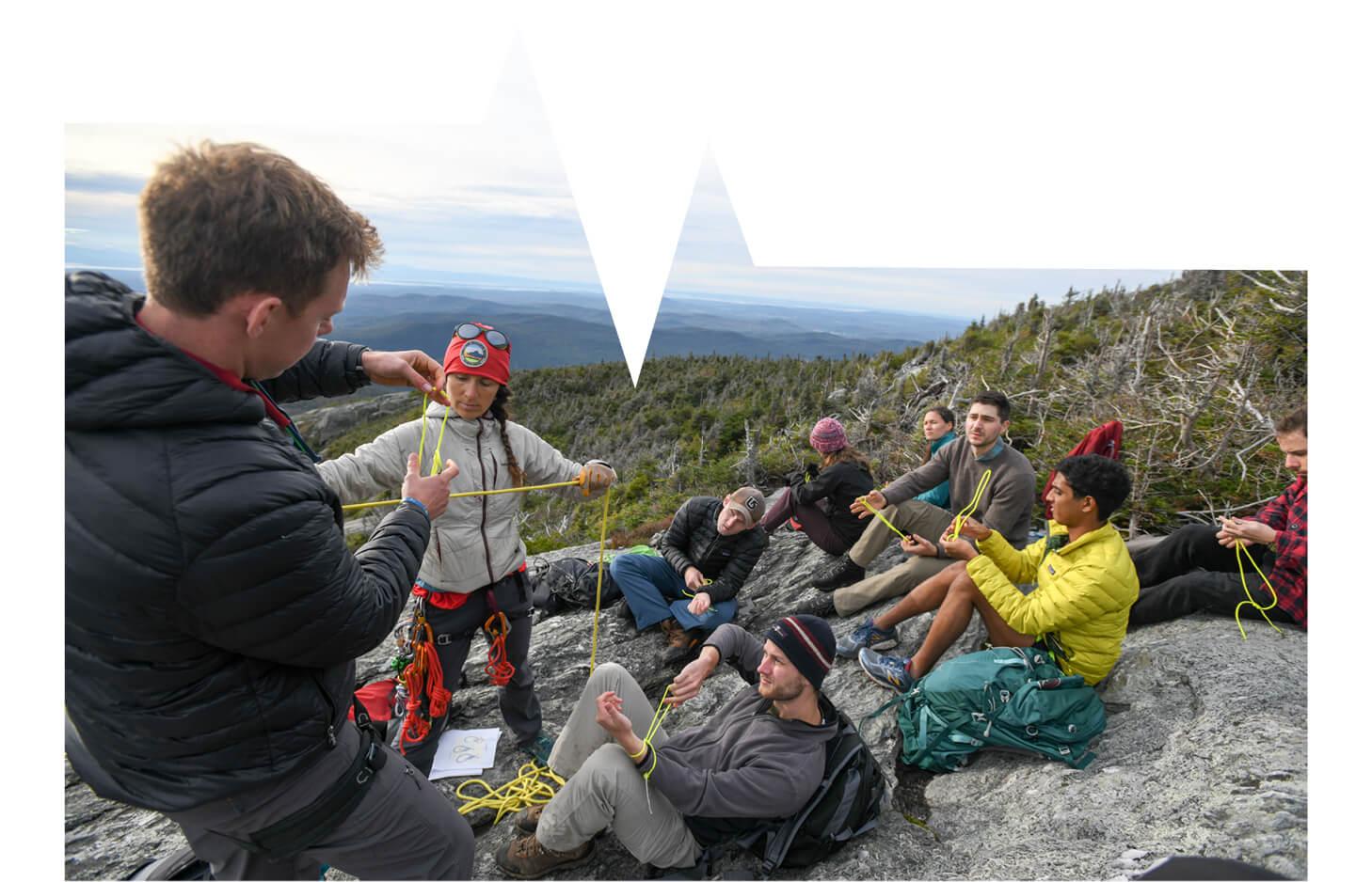 Medical students on mountainside learn rope tying skill