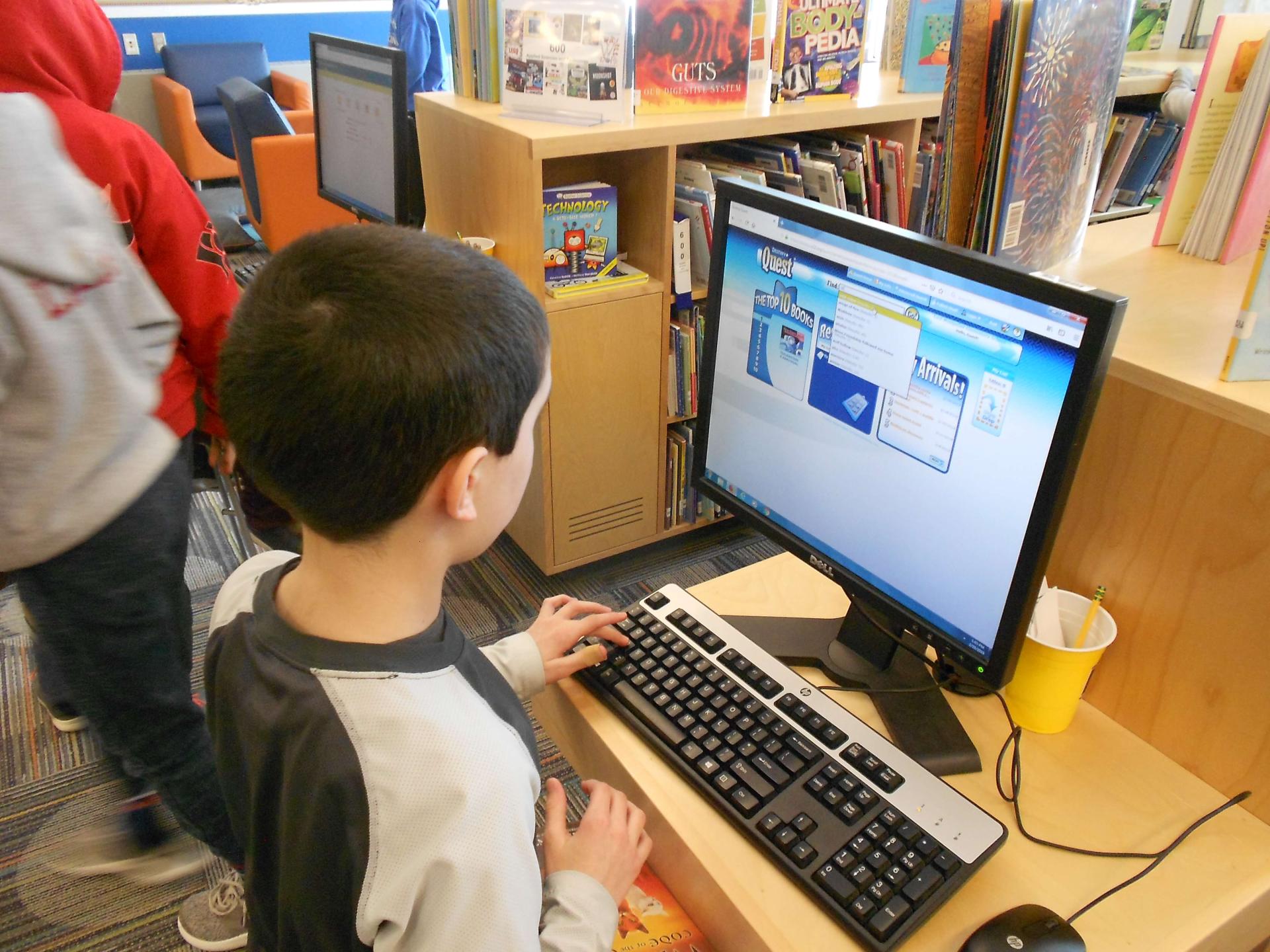 Student doing research on school library computer
