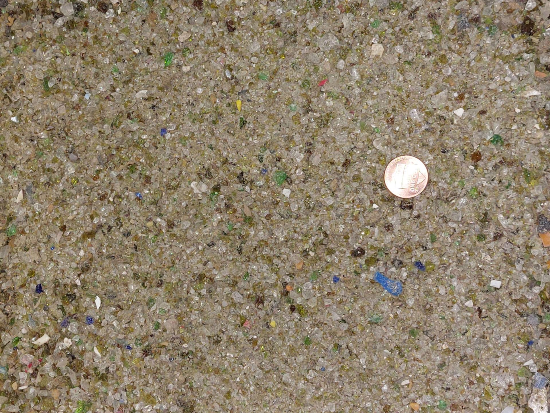 Small pieces of glass with a penny for scale.