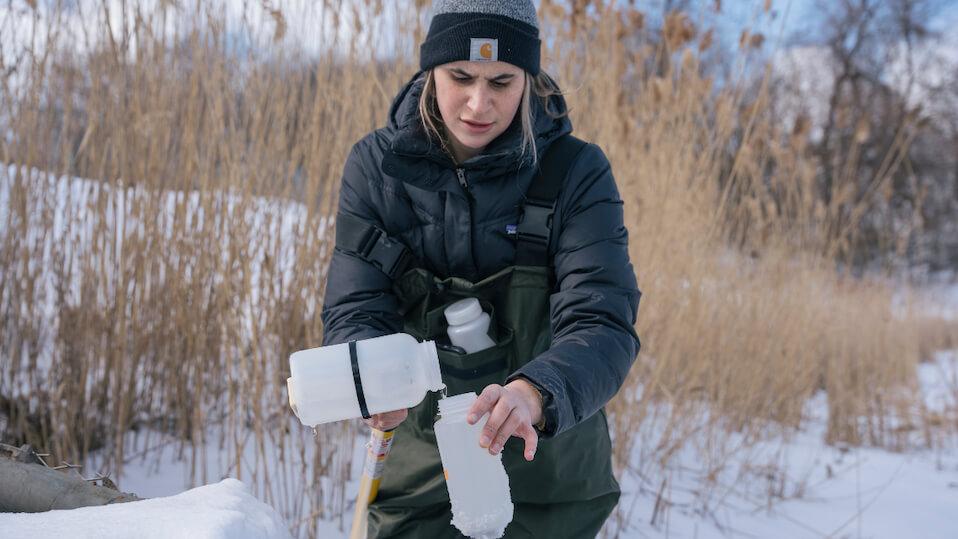 researcher sampling water 
