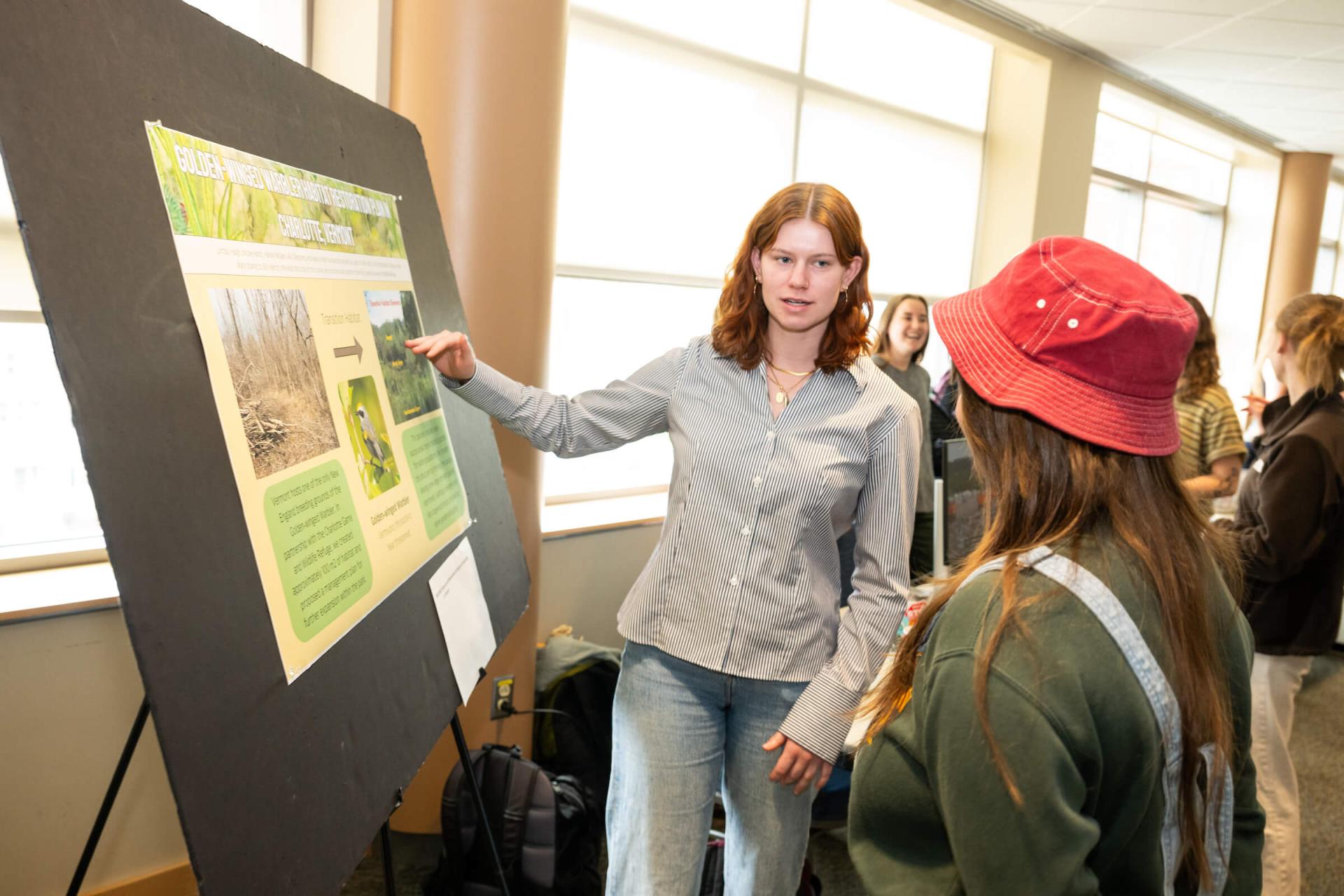A UVM senior presents their service learning activities at the Davis Center