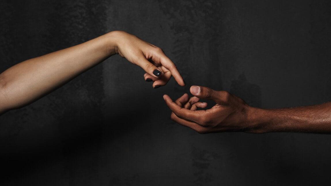 Hands reaching for each other