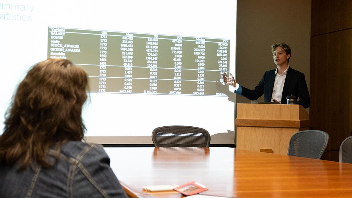 Sam Thompson defends his honors thesis.
