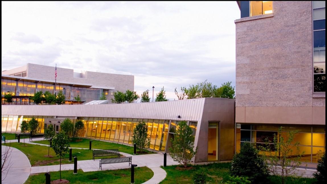 a group of buildings with a walkway connecting them