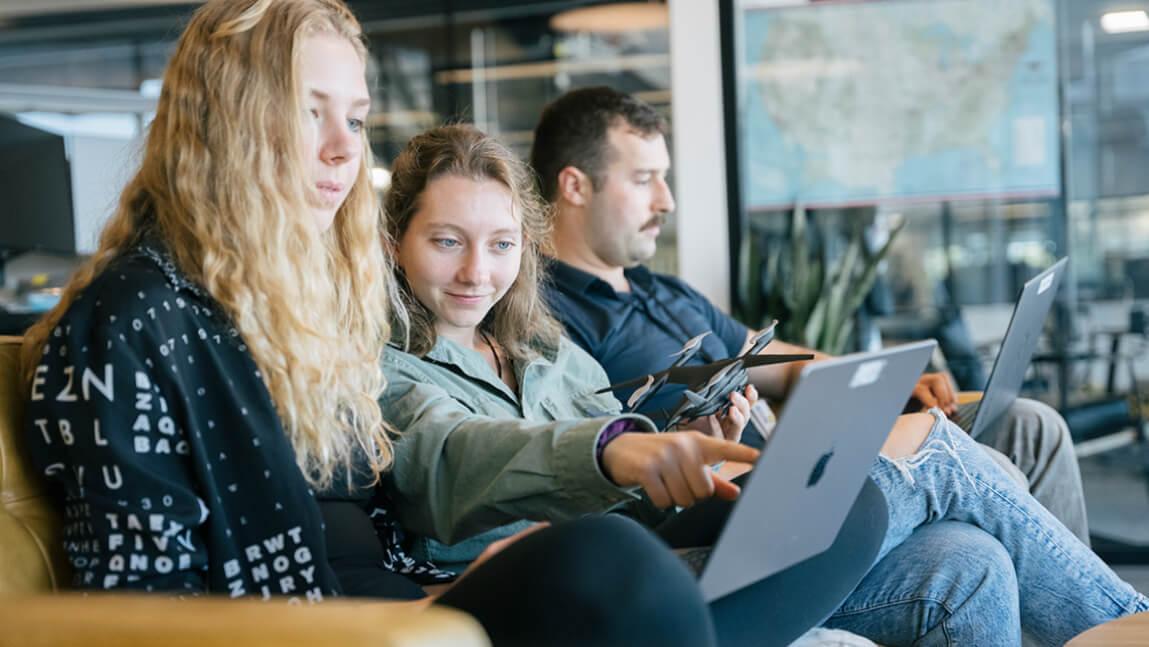 Three college students working.