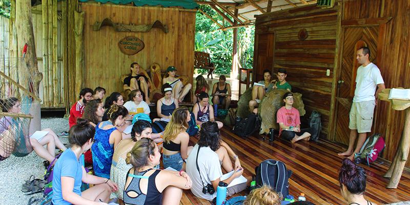 Students in Costa Rica outdoor classroom listen to a community partner speak