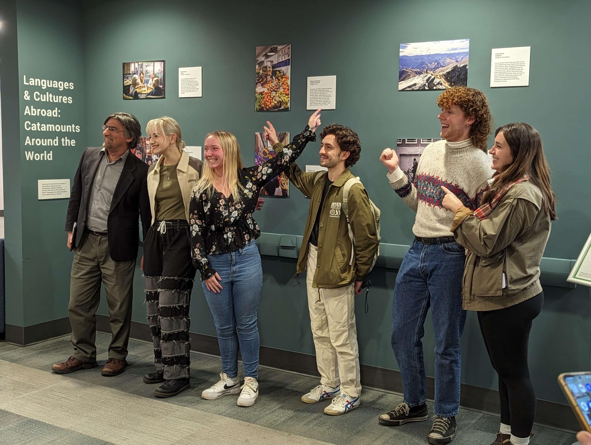 students point to their winning photos