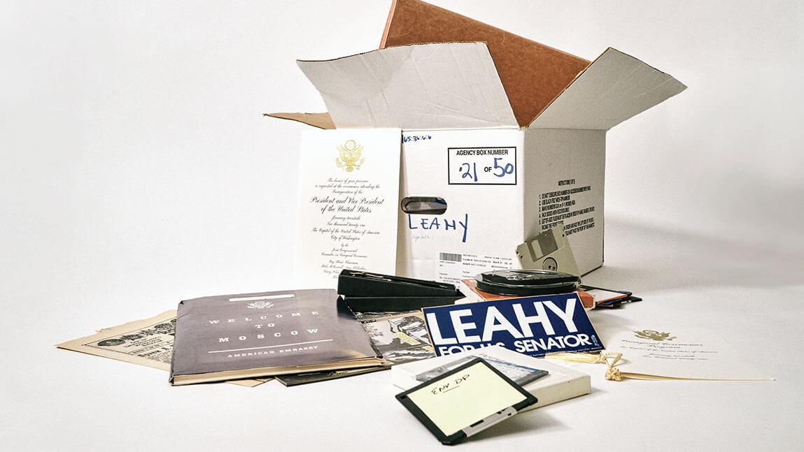 a box full of items from senator Leahy's career are displayed against a white screen