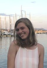 Smiling student with sailboats in the background.