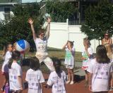 Demonstrating an exercise to a group of children.