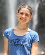 Smiling student in a blue t-shirt.