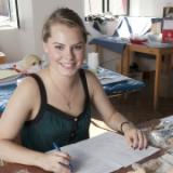 A student writes in a notebook.