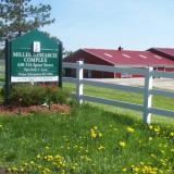 uvm sign in front of farm building